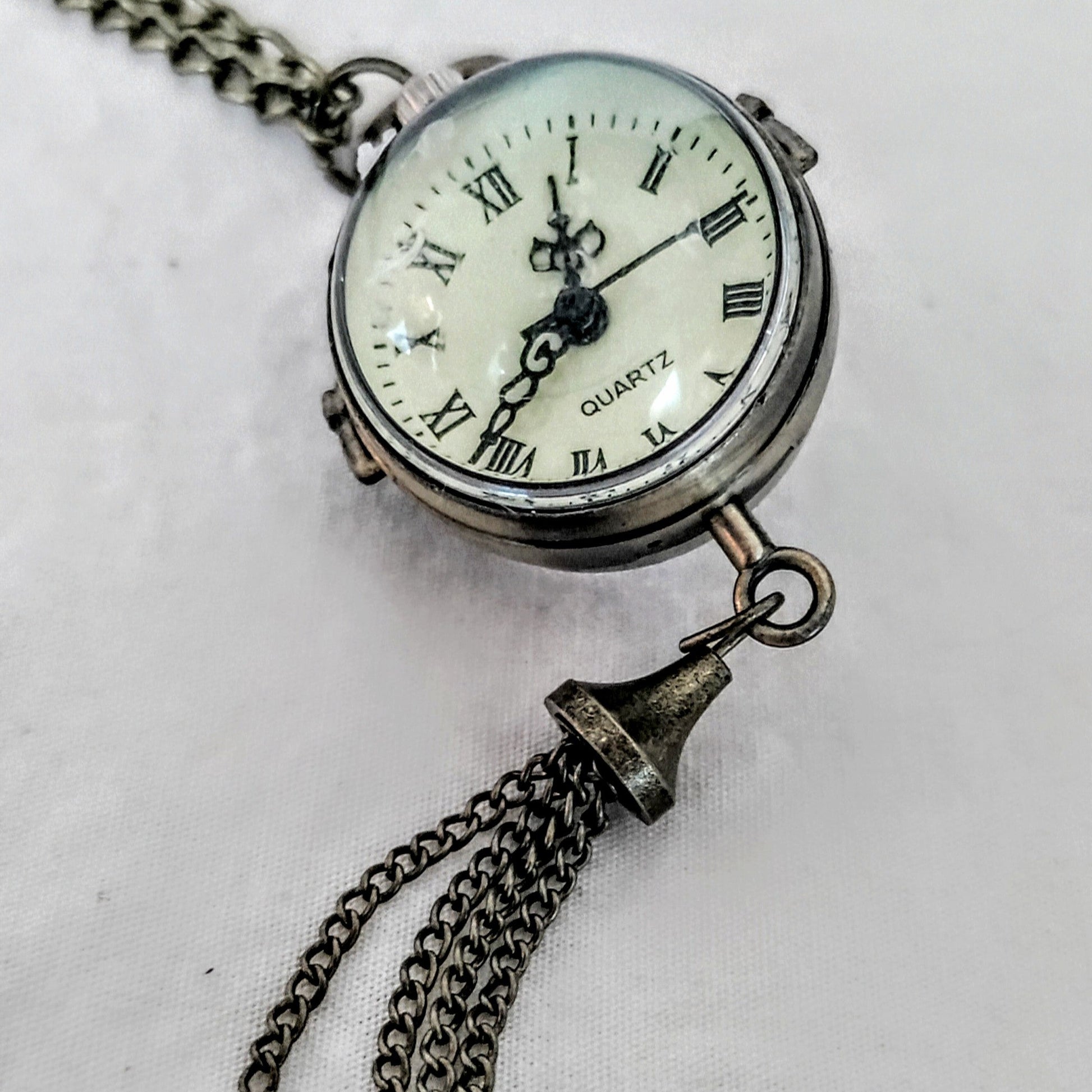 Pocket watch with chain on a white background