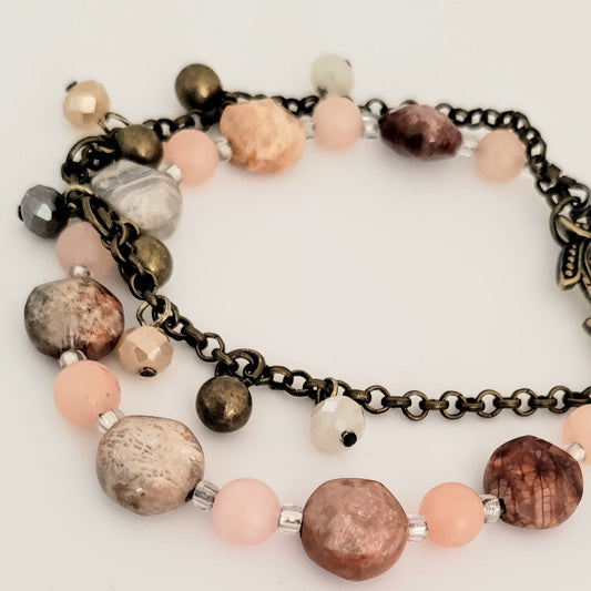 Bracelet with multicolored beads and chain on a white background